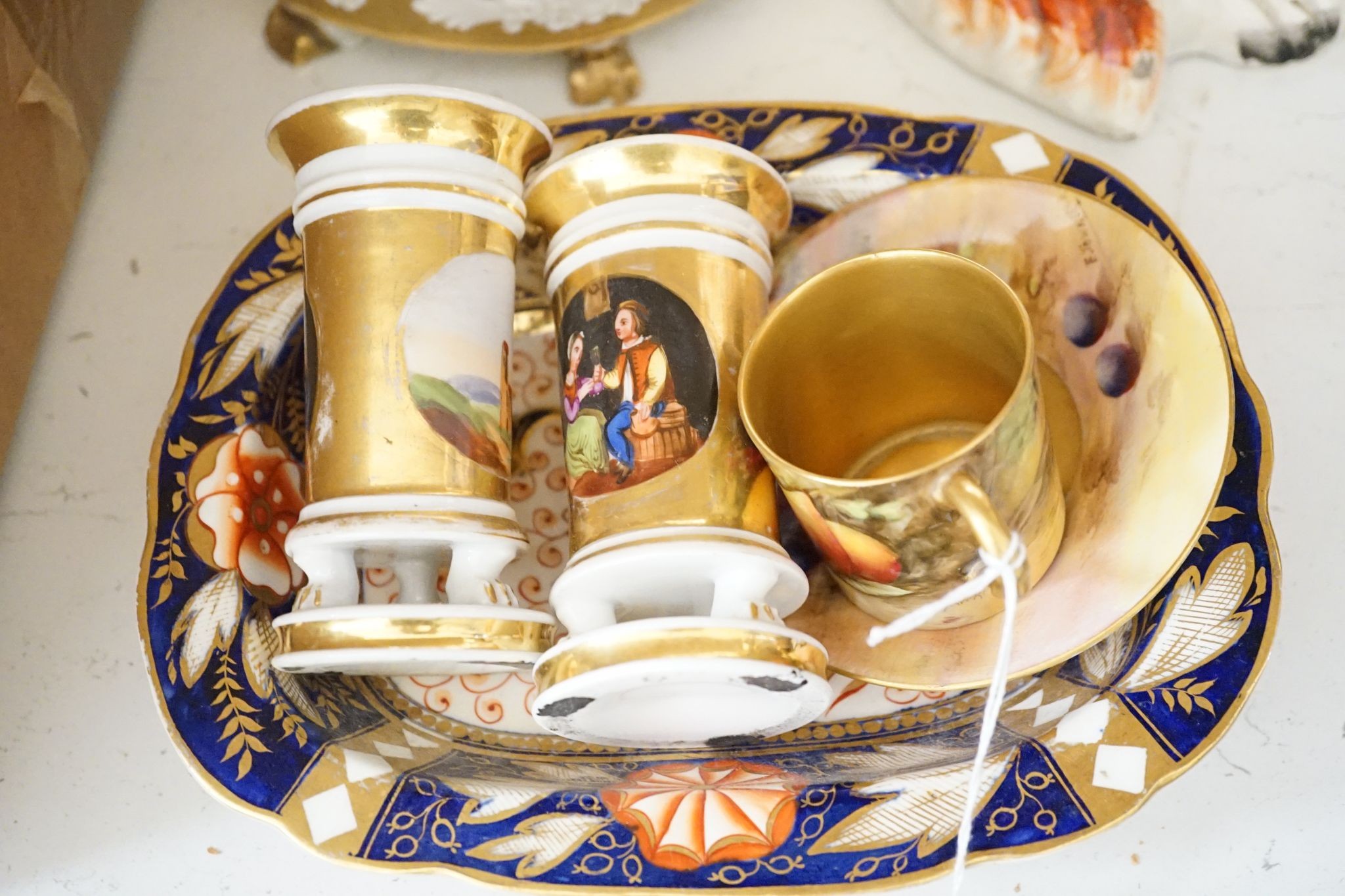 A pair of bisque swinging figures, Royal Worcester cabinet cup and saucer and five other items